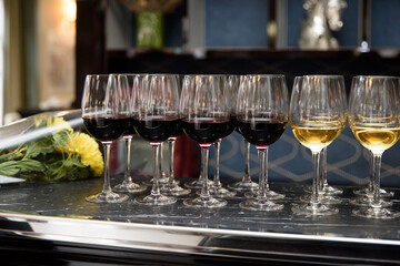 Glasses of red and white wine, bar. Expensive drink