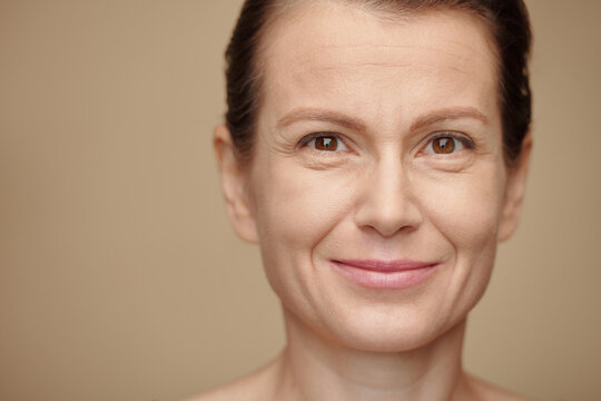 Face of smiling mature woman looking at camera