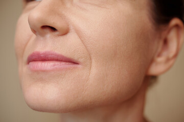 Mature woman with nasolabial folds, selective focus