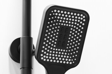 Black modern shower head on a shower column close-up