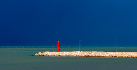The pier of Trani with the red lighthouse, province of Barletta-Andria-Trani on Adriatic sea, Apulia, Italy - obrazy, fototapety, plakaty