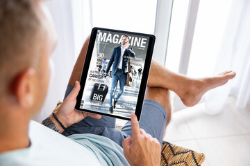 Man reading magazine on tablet computer
