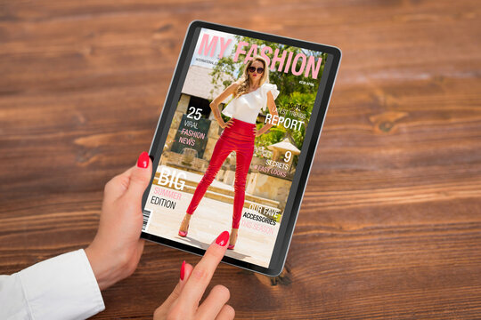 Woman reading digital edition of fashion magazine on tablet computer