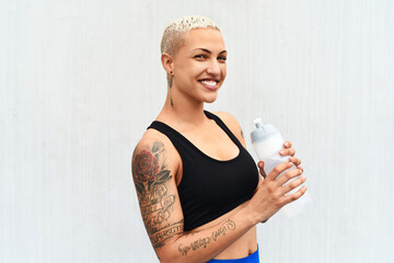 I stay hydrated. Cropped portrait of an attractive young female athlete drinking water against a grey background.