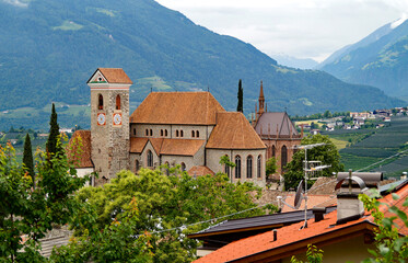 Mediterranean landscape in the Italian Alps with the old parish Church of Scena (Schenna) in Merano (Meran) region in South Tyrol (South Tirol), Italy - obrazy, fototapety, plakaty