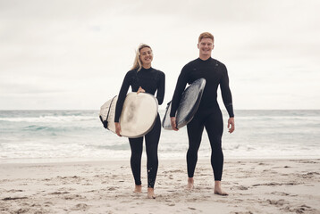 Weve experienced the greatest highs and toughest lows by surfing together. a young couple out at the beach with their surfboards.