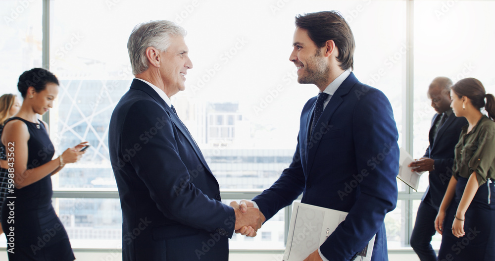 Poster ive heard great things about your work. two businesspeople shaking hands while colleagues are blurre