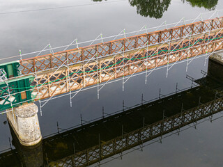 Scaffolding used for maintenance or restoration work on a small bridge over a large river the Cher
