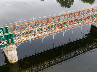 Fototapeta premium Scaffolding used for maintenance or restoration work on a small bridge over a large river the Cher
