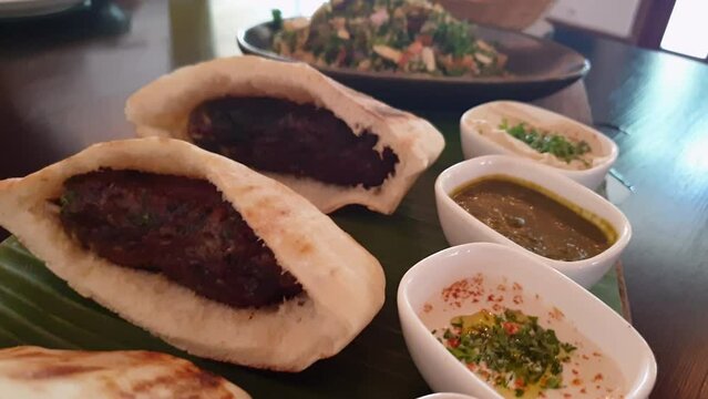 Lamb kebab stuffed in Pita bread serve with Tabouli salad and fries Lebanese food