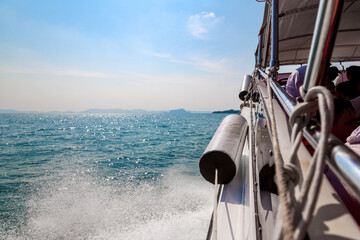 Waves from a speedboat on the blue sea with splashes and a trail from a boat or yacht. The concept...