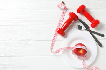Fototapeta na wymiar Concept of weight loss and healthy nutrition with apple and measuring tape