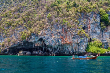 Fototapeta na wymiar Viking caves on Phi Phi Le island in the Andaman Sea with pirates hiding treasures. Travel and excursions in Thailand Phuket island.