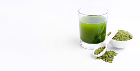 Green powder vegetables for health. Green matcha tea powder in small white bowl on white background. Banner with space for text.