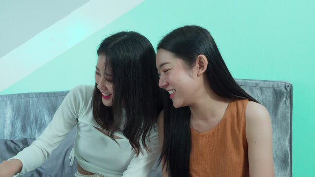 Asian toursit girls seraching information planning for vacation trip, young backpacker using laptop in hostel, woman texting message on technology notebook digital nomad working or shopping online
