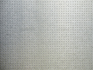 Perforated metal surface. Gradient aluminum background. Patterns on metal.
