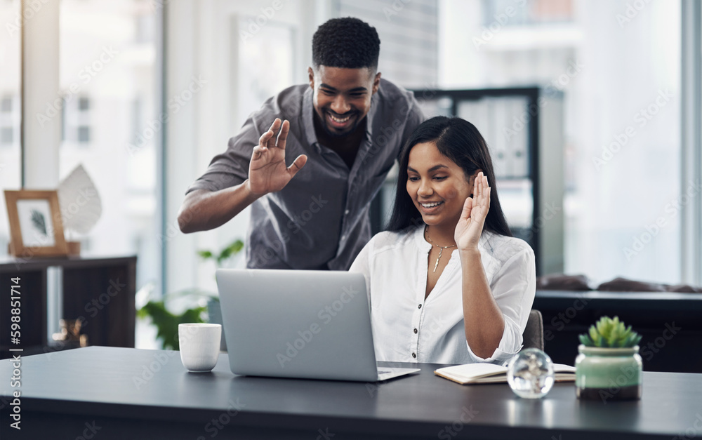 Poster greeting their clients across the globe. two businesspeople making a video call on a laptop in an of
