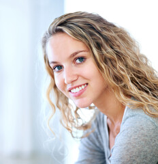 A sweet smile just for you. Portrait of a pretty young blonde smiling at you sweetly.