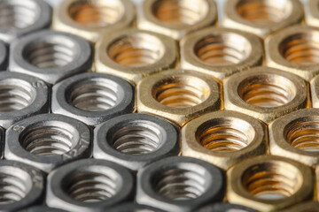 Metallic hex nuts layed out in a hexagonal pattern