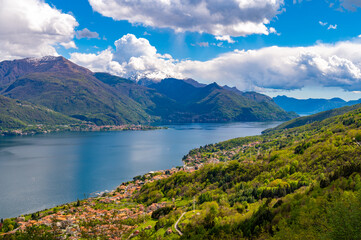 Fototapeta na wymiar View of Lake Como, towards the south, from the church of San Bernardo in Musso, with the mountains above, Dervio, the streets and the villages bordering the lake. 