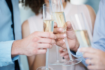 Toasting their success. Cropped image of a group of businesspeople toasting champagne to their success.