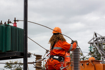 Line woman connecting power lines in developing cities