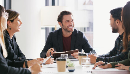 Pulling together to create another foolproof plan. a group of businesspeople having a meeting in a boardroom.