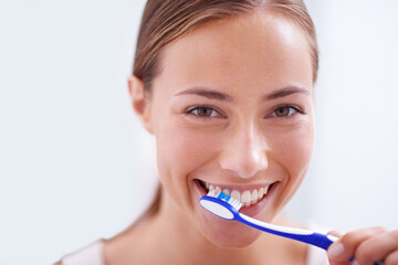 Woman, portrait and brushing teeth in bathroom with smile, health and self care for oral hygiene, wellness and routine. Girl, toothbrush and happiness for cleaning, healthy mouth and start morning