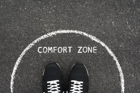 Comfort zone concept. Feet standing inside comfort zone circle.