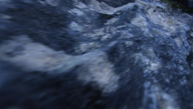Dynamic macro shot of the frozen rock of a cliff at dawn, in the Alps, Switzerland