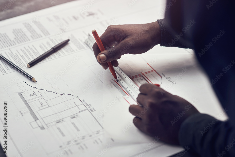 Poster putting his expertise to work. high angle shot of an unrecognizable male architect making some measu