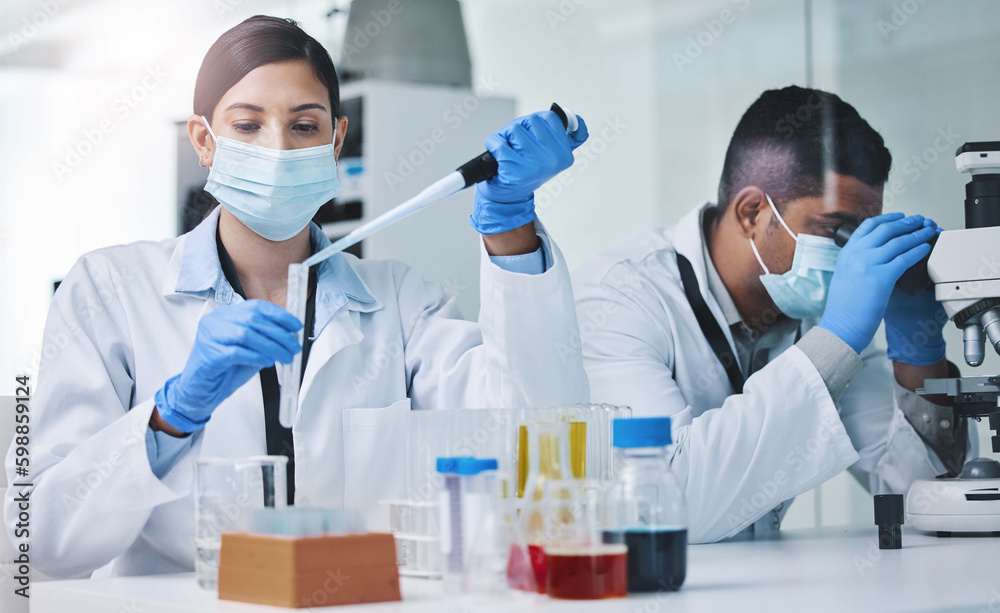 Poster putting our skills to work. two young researchers working in a laboratory.
