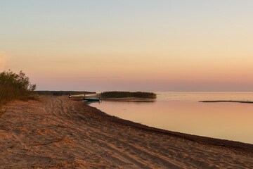 Sandy beach of Lake Ladoga on the south side at sunset