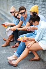 Fototapeta premium Catching up - Friends. Young hipster friends sitting together outdoors.