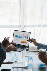 Group of businessmen, investors discussing and meeting based on documents laptop to analyze and discuss financial report situation in conference room accounting concept.