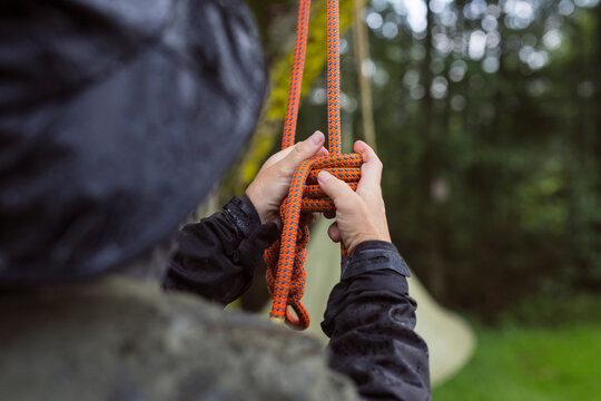 Close-up of man tying climbing rope