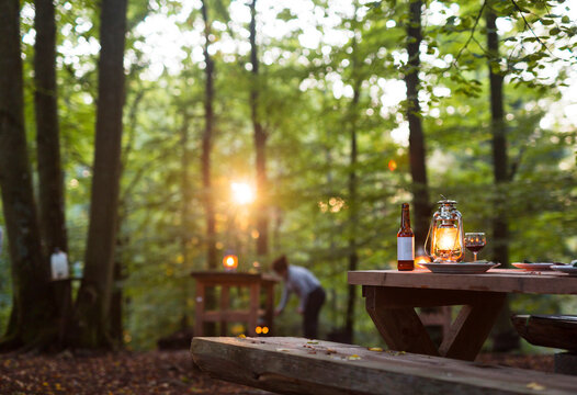 Picnic table in forest at sunset