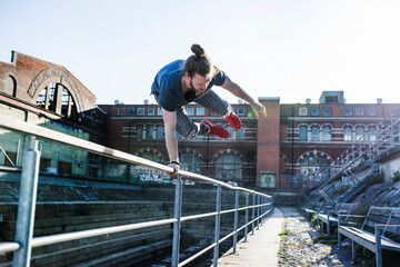 Young man doing parkour in city