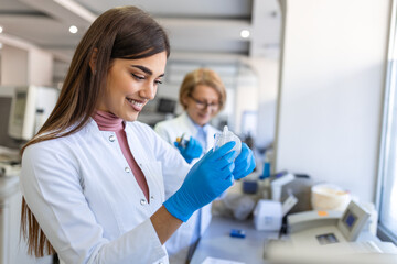 Female Medical Research Scientist Looks at Biological Samples Before Analysing it Under Digital...