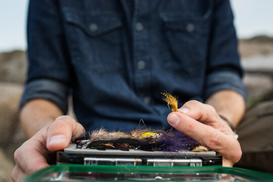 Close-up of man holding fishing bait