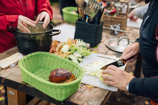 People preparing food on table outdoors