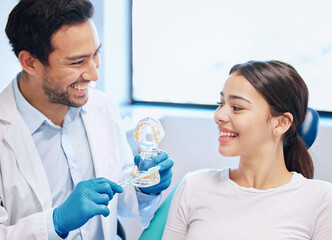 The superior way to brush. a dentist demonstrating the best way to brush teeth to a patient.