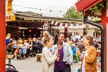 Young female friends relaxing in beer garden