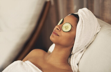 Indulging in some much-needed me time. a woman relaxing in a spa with cucumber slices on her eyes. - Powered by Adobe