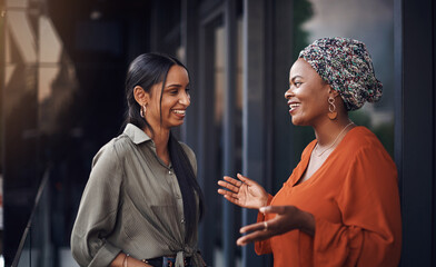 Lets talk business. two attractive businesswomen discussing work in their office.