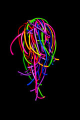 rainbow rubber bands on a dark background