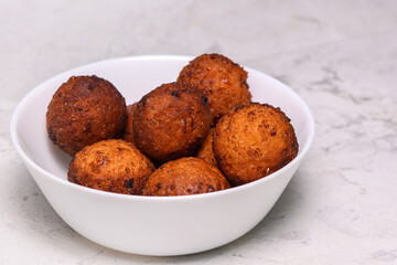 baked curd balls in a white plate on a marbled kitchen table 1