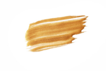 A dab of gold paint on a white background.