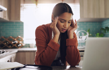 Headache city admit one. a young businesswoman suffering from a headache while working at home.