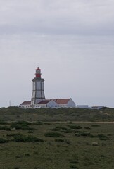 Fototapeta na wymiar Sesimbra, Portugal - April 4, 2023: Cape Espichel Lighthouse (Lighthouse Cabo Espichel) is a coastal lighthouse located in the parish of Castelo, district of Setubal. Built in 1790. Selective focus.